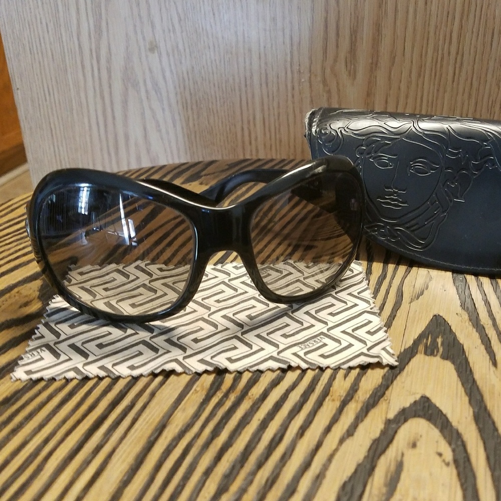 black Versace glasses with a madusa on the sides